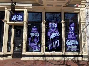 Purple paintings on a series of windows. 