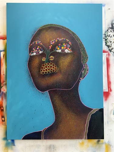 A portrait of a person with a blue background. 