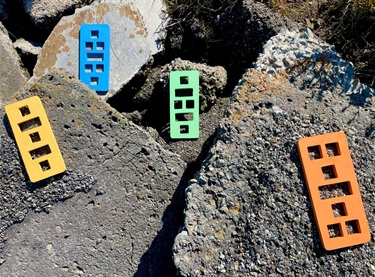 Abstract pieces of artwork laid on rocks. 