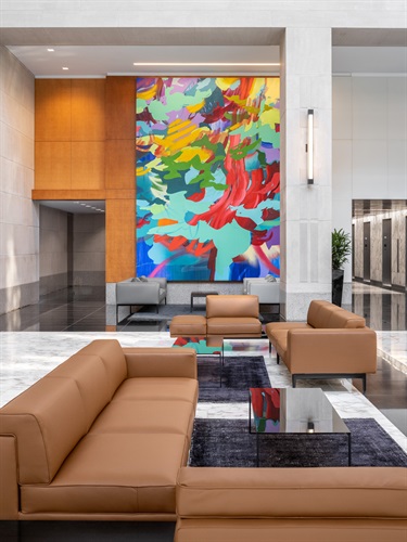 A large painting on the wall of a lobby. 