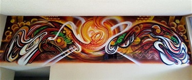 A mural on a wall next to the ceiling. 