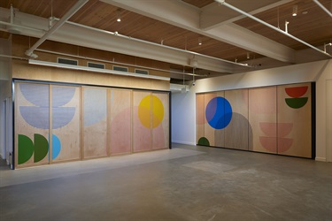 A mural painted on a series of walls in a corridor. 