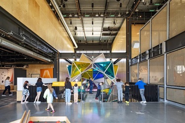 People viewing a sculpture.