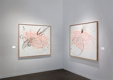 Two abstract paintings on a white wall.