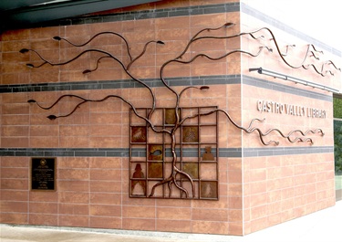 An abstract sculpture on the side of a building.