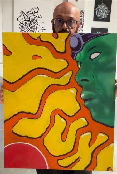 A person holding a piece of abstract art. 