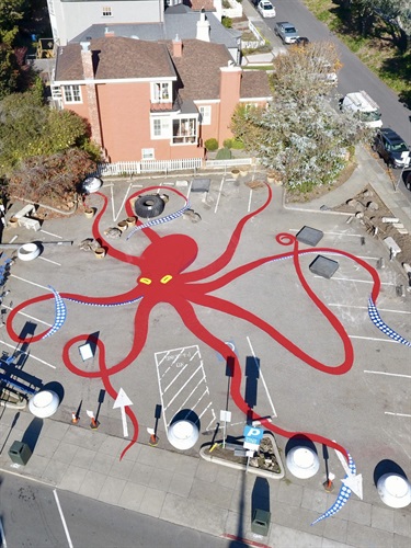 An aerial view of a mural painted on a street. 