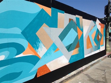 A mural painted on the side of a building. 