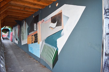 A mural painted on a wall at a construction site. 
