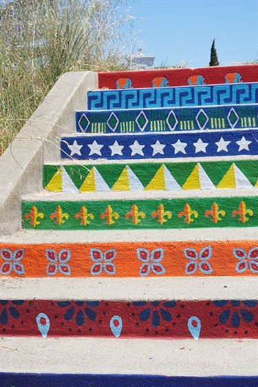 A staircase painted with colorful patterns. 