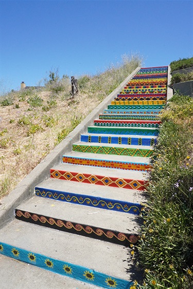 A staircase painted with colorful patterns. 