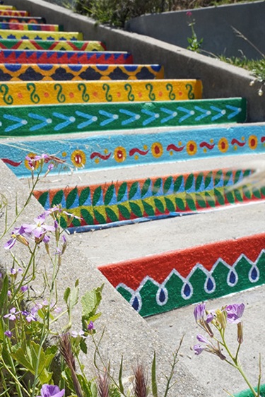A staircase painted with colorful patterns. 