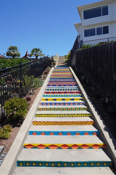 A staircase painted with colorful patterns. 