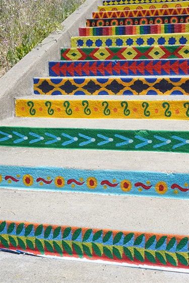 A staircase painted with colorful patterns. 