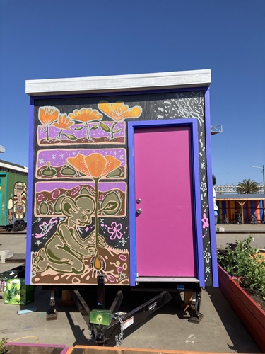 A mural painted on the outside of a portable shed. 