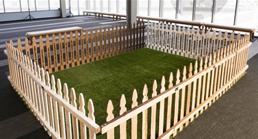 A an area surrounded by a picket fence. 