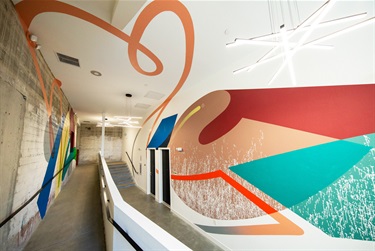 A mural painted on a wall in a hallway.