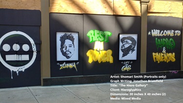 Artwork on a building next to a sidewalk. 