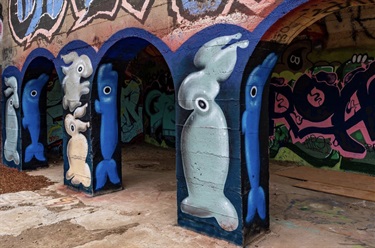 A mural painted on a building archway.