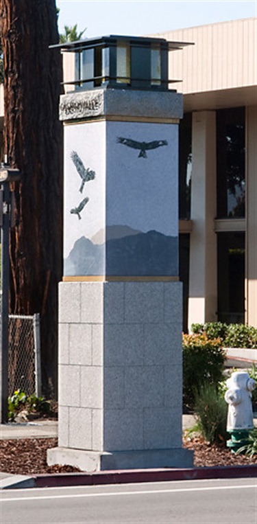 A concrete sculpture near a road. 