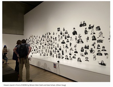 People looking at an art installation in a gallery. 