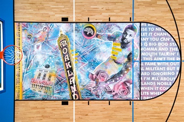A mural on a basketball court floor. 