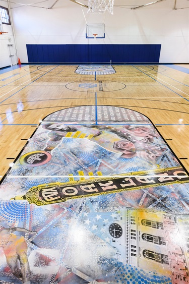 A mural on a basketball court floor. 