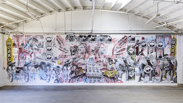 A collage style mural on a building wall.