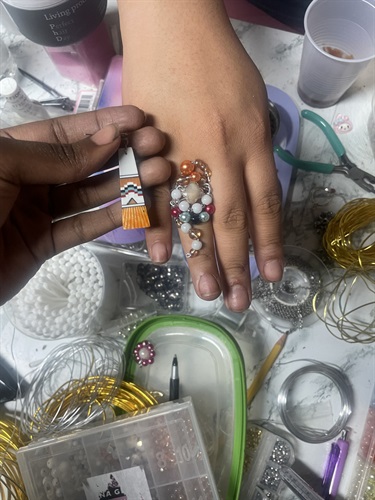 Two hands with jewelry.