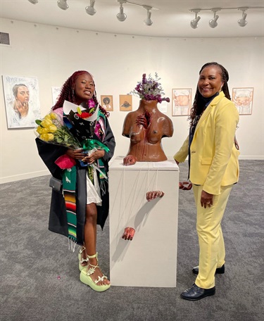 Two people in a gallery. 