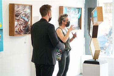 Two people in an art gallery.