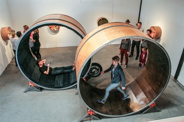People interacting with an art installation in a gallery.