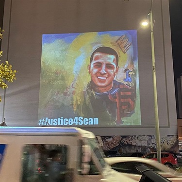 A piece of artwork projected on the wall of a building. 