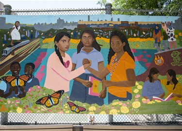 A painting attached to a chain link fence. 