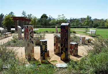 A group of abstract sculptures in a park. 