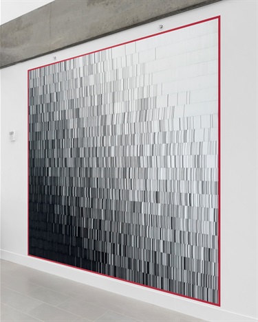 A piece of abstract artwork on the wall of a building. 