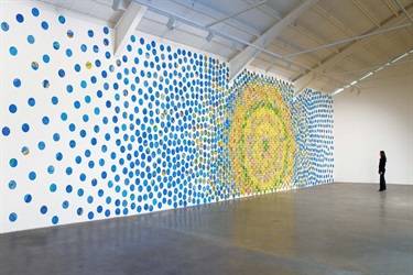 A piece of abstract artwork on the wall of a building. 