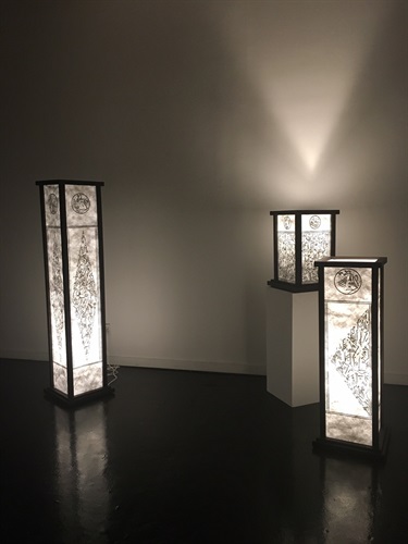 Three lanterns in a dark room. 