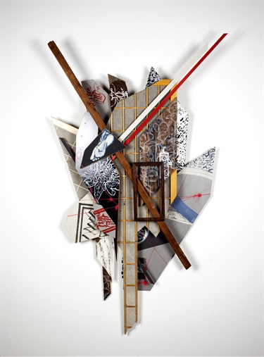 A mixed media artwork on a white wall. 