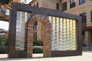 An abstract sculpture in front of a building.