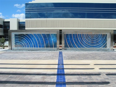 An abstract sculpture in front of a building.