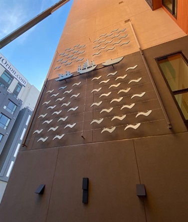 Artwork attached to the wall of a building. 