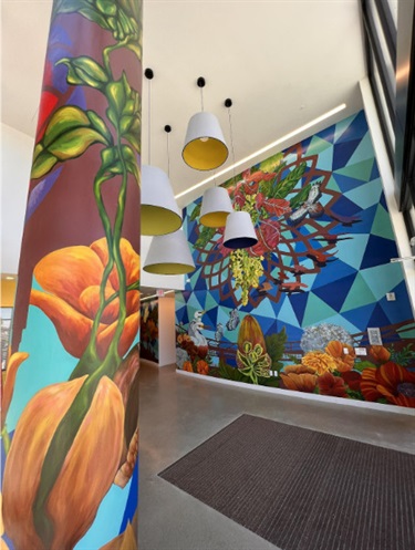 A mural painted on the wall and column of a building. 