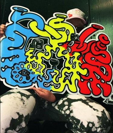 A person holding a piece of abstract art. 