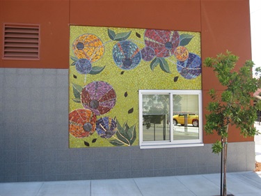 A colorful mosaic on the wall of a fire station. 