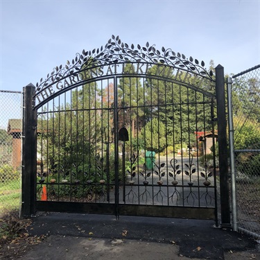 An ornamental metal gate with the words 