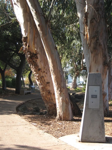 A concrete sculpture on the side of a walkway. 