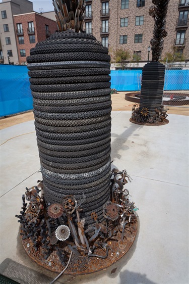 A sculpture next to a city sidewalk.