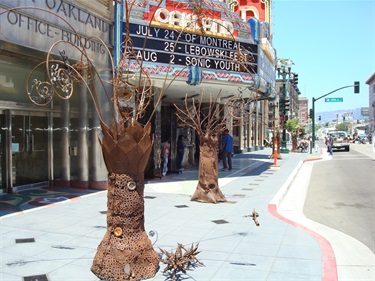 Two metal sculptures depicting abstract trees.