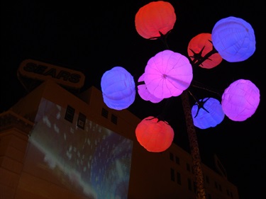 A purple, pink, and red light sculpture.